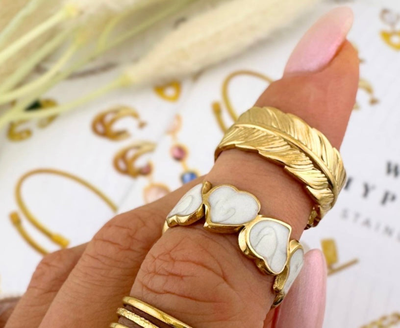 Beautiful & stylish heart ring with ceramic white heart inlays.Matching necklace and earrings also available. Code 87119